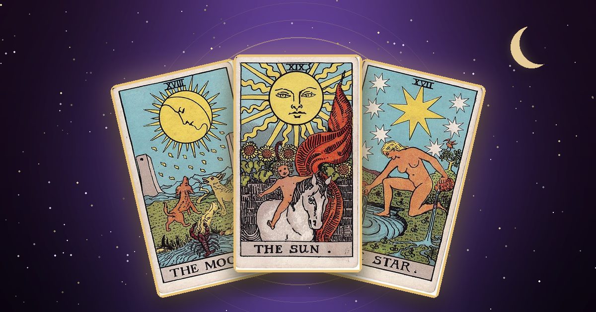 The Moon, The Sun and The Star tarot cards under a night sky